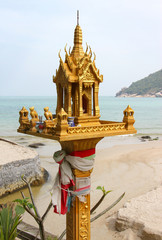 traditional Thai spirit house in front of sea landscape - 78499248