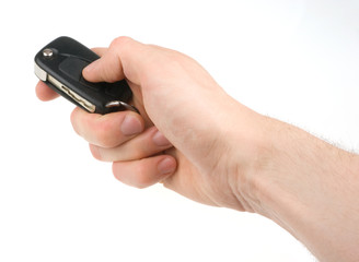 Hand holding car keys isolated on white background