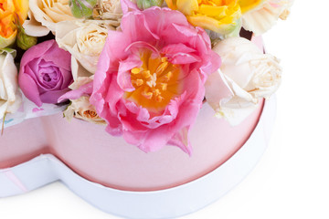 Flower bouquet in a heart shaped box isolated on white