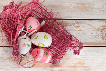 Colorful Easter Eggs on old white wooden board