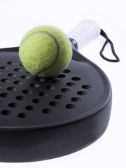 closeup of a paddle racket and ball