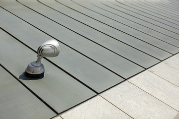 Halogen metal reflector on modern building grey wall