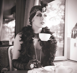Retro Woman 1920s - 1930s Sitting with Cup of Tea