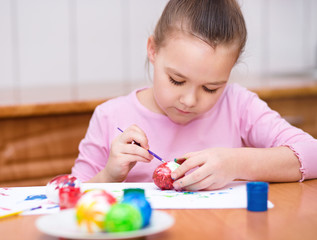 Girl are coloring eggs