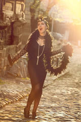 Retro Woman 1920s - 1930s in Rays of Setting Sun