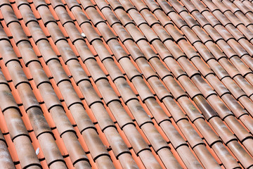 Closeup of many red clay roof tiles