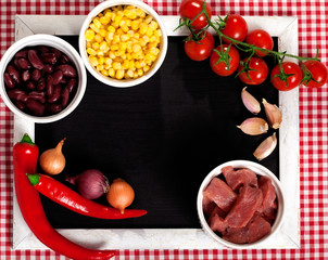 ingredients for mexican chili on a black chalk board