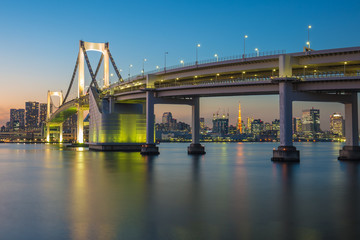 Rainbow bridge at night with Tokyo tower in background