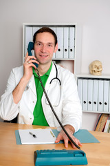 young family doctor in his office