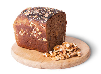 Unleavened bread with seeds on wooden board with nuts