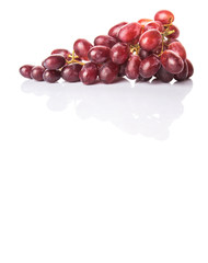 Red grapes over white background