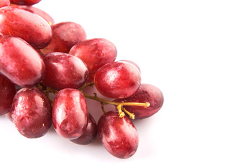 Red grapes over white background