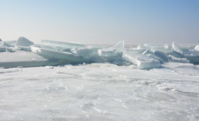 Fototapeta na wymiar Hummock on the frozen sea shore at spring season
