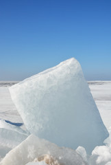 Hummock on the frozen sea shore at the spring season
