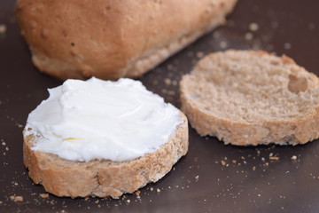 Slice of bread with cream cheese.