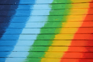 Bright and colored wooden background with rainbow colors