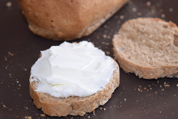 Slice of bread with cream cheese.