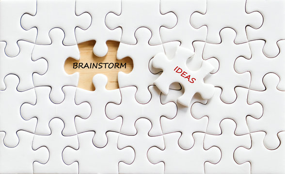 Brainstorm and ideas words on jigsaw puzzle background, business