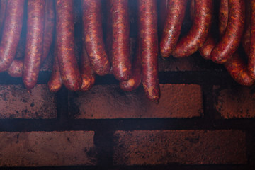 Traditional food. Smoked sausuages in smokehouse.