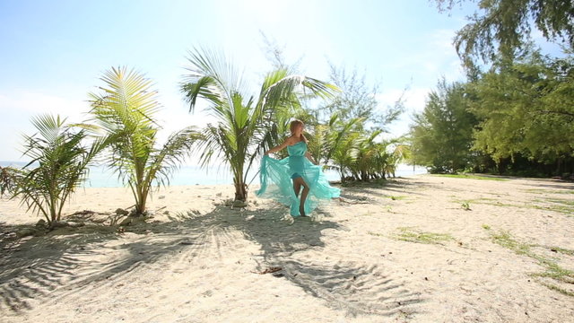 asian girl's gorgeous blue dress blows under wind near small pal