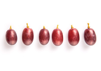 Red grapes over white background