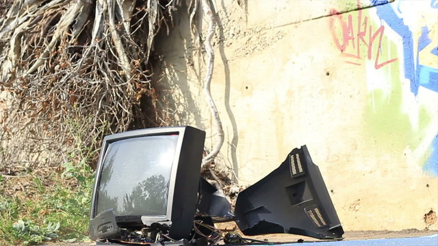 Old TV set shatters on the ground