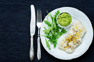 cod baked with lemon and spices with arugula and mashed green pe