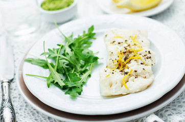 cod baked with lemon and spices with arugula and mashed green pe