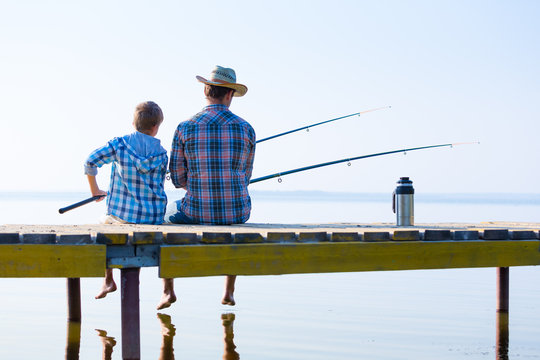 Boy And His Father Fishing Togethe