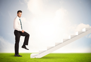 Business person climbing up on white staircase in nature