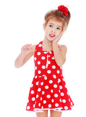 Adorable little girl with a bow on her head.