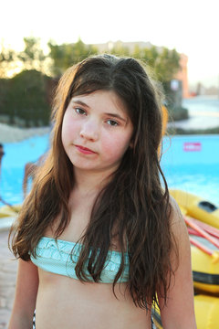 three preteen girls in open air  swimming pool in egypt