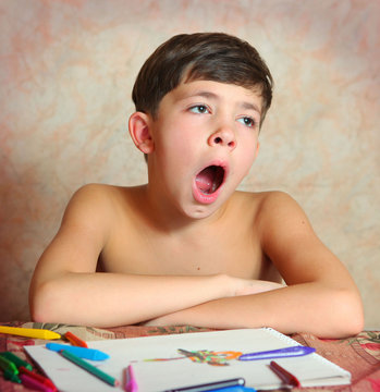 Handsome Preteen Boy Yawn While Drawing