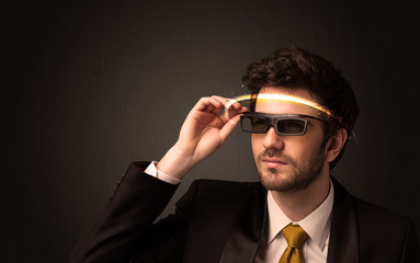 Handsome man looking with futuristic high tech glasses