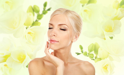 Beautiful young woman on freesia flower background