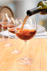 Red wine pouring into wine glass, close-up