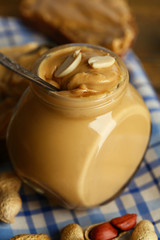 Fresh peanut butter in jar, close up
