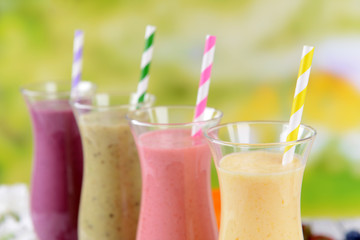 Delicious berry cocktails on table on bright background