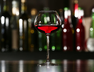 Glass of wine with bar on background