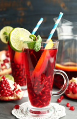 Pomegranate drink in glasses with mint and slices of orange and