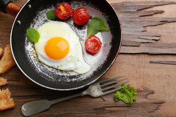 Bacon and eggs on rustic wooden planks background