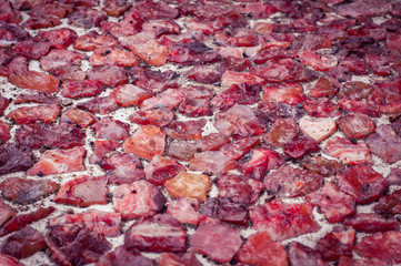 Red stones lying on a road