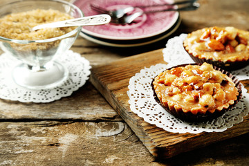 Mini cakes with nuts on wooden background