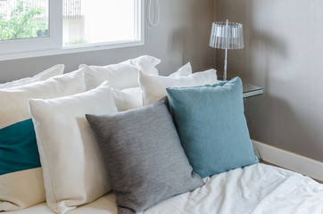 grey and green pillow on white bed in modern bedroom