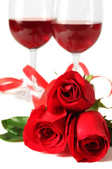 Fototapeta na wymiar Composition with red wine in glasses, red roses, ribbon and