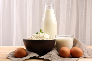 Tasty dairy products on table on fabric background