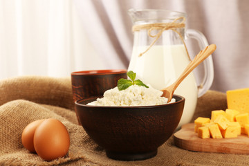 Tasty dairy products on table on fabric background