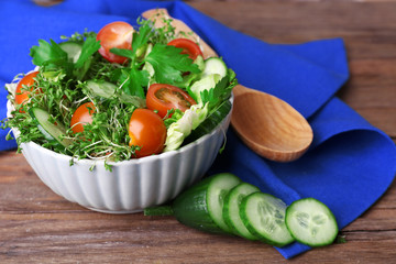 Cress salad with sliced cucumber, cherry tomatoes and parsley