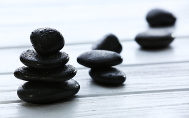 Spa stones with water drops on wooden background