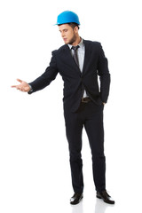 Businessman with hard hat holding copy space.